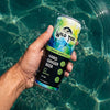 A can of Original Ginger Lime ginger beer held by a guy's hand in the pool.