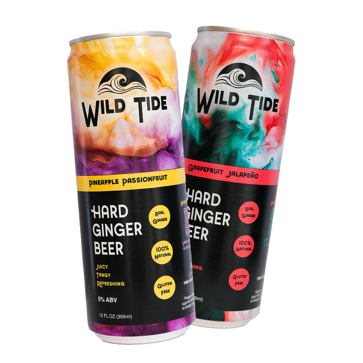 Two cans of Wild Tide Hard Ginger Beer with colorful labels on a translucent background